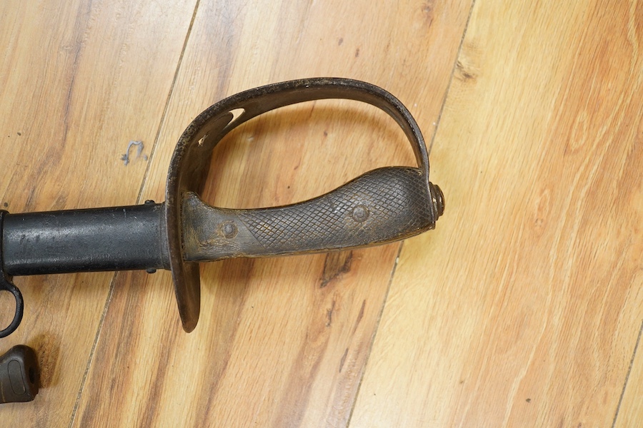 A First World War Turkish army officer’s sword, with pipe back blade, regulation iron guard pierced with crescent and moon, chequered horn grips, in its iron scabbard, together with an unidentified bayonet in its scabbar